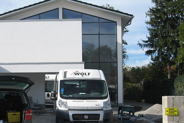 Auto von Holzbau Wolf vor dem Holzhaus